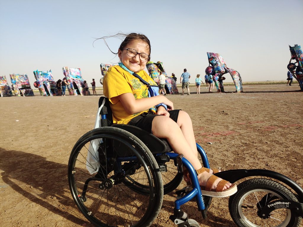 Girl in wheelchair shows how Cadillac Ranch can be wheelchair accessible.