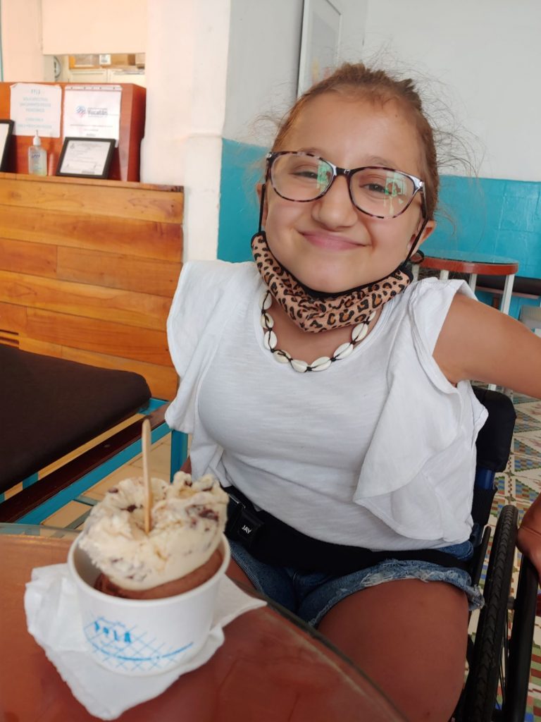 Teen in wheelchair at gelato shop Pola in Merida, Mexico to review accessibility.