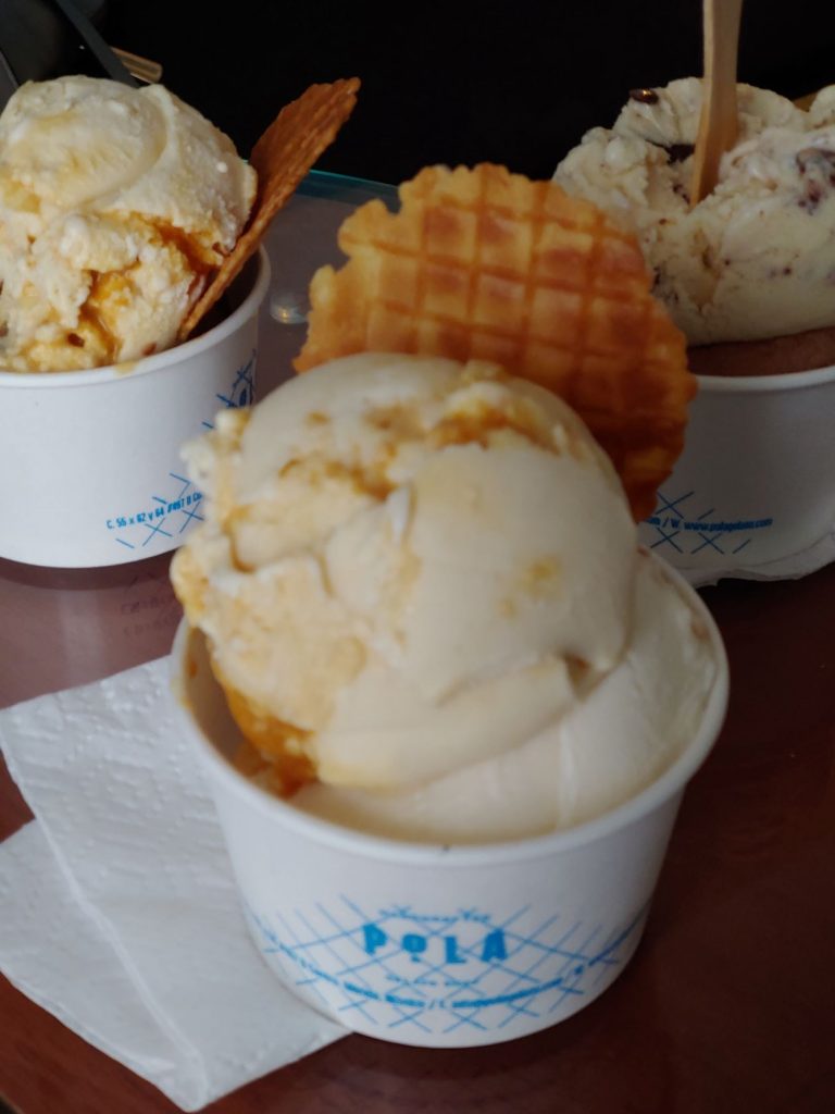 Gelato displayed in front of the sign at Pola in Merida, Mexico.