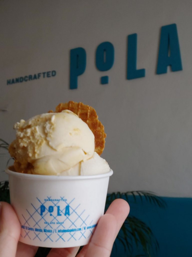 Gelato displayed in front of the sign at Pola in Merida, Mexico.