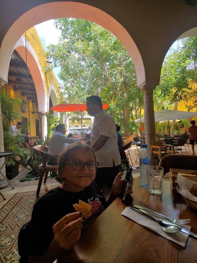 Girl in wheelchair enjoying the Yucatan dining at MUGY in Merida, showing how accessible the restaurant is.