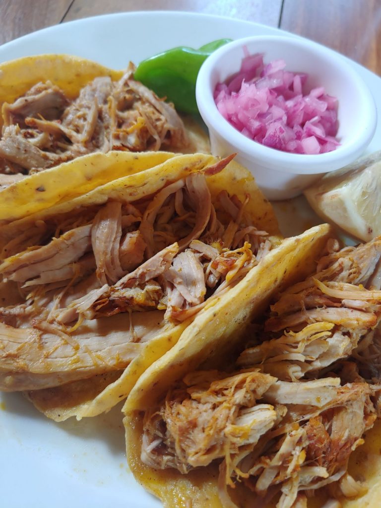 Pork tacos served with bright pink pickled onion from accessible Yucatan restaurant, MUGY, in Merida.