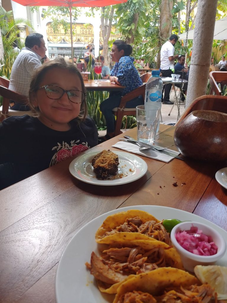 Girl in wheelchair enjoying the Yucatan dining at MUGY in Merida, showing how accessible the restaurant is.