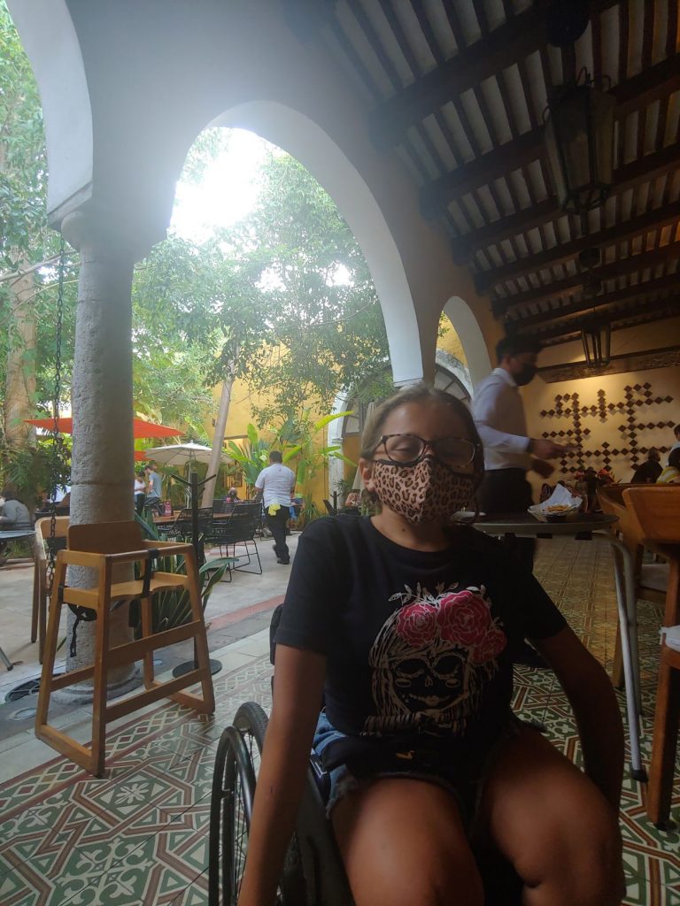 Girl in wheelchair enjoying the ambiance at MUGY in Merida, Mexico.