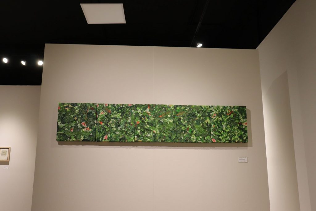 Pentaptych of abstract green foliage with scattered pink flowers. This set of art in five pieces appears to be oil paint on canvas panels side by side. Small descriptive panel beneath.