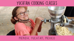 Girl in wheelchair learning to grind corn to make tortillas during accessible Spanish lesson in Merida, Mexico.
